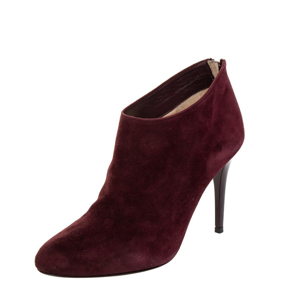 Impeccably crafted into a stylish silhouette, these burgundy ankle boots from the house of Jimmy Choo will help you create a refined style statement. They are made from suede and fashioned with back zippers and 8 cm heels.

