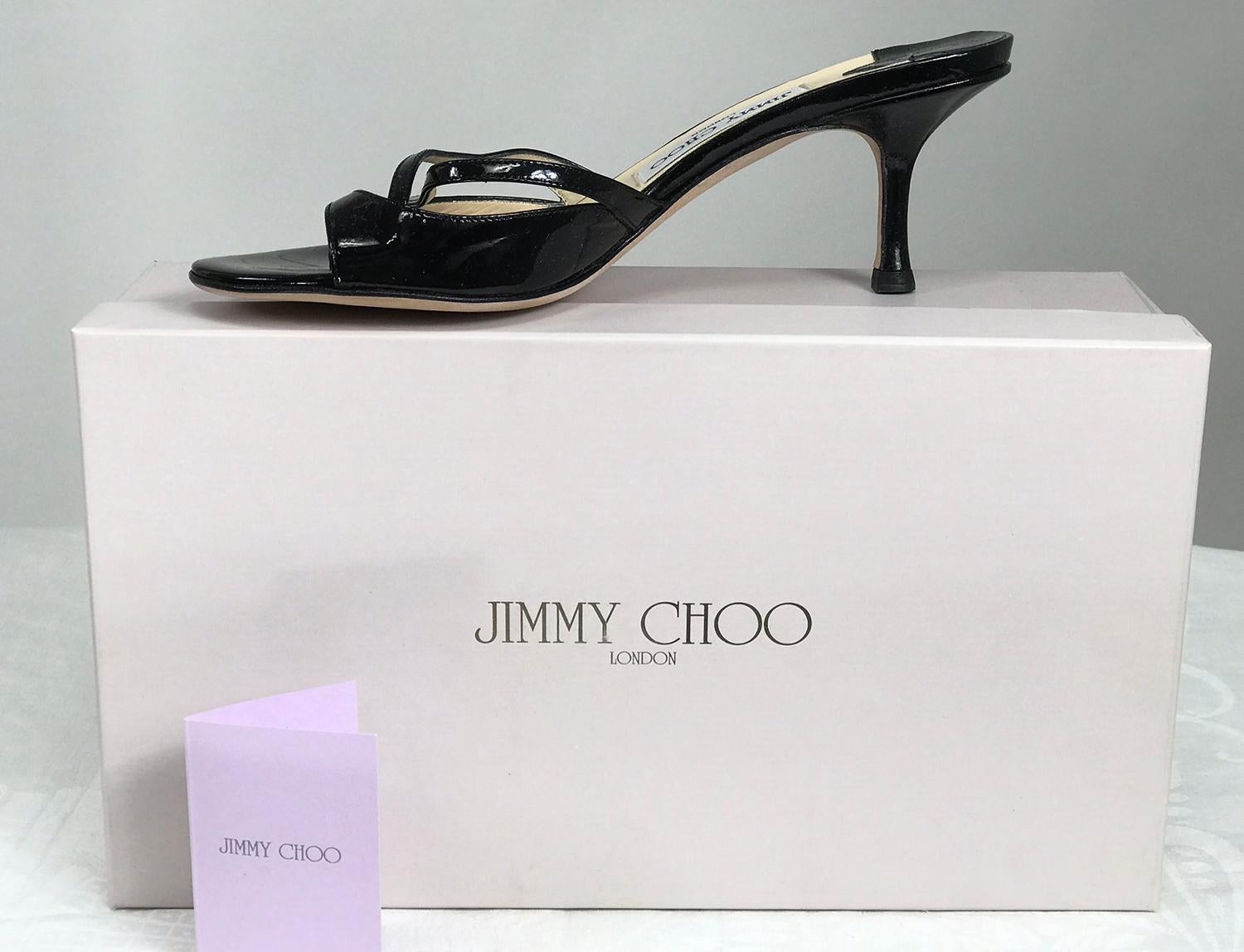 Jimmy Choo Calais.1 black patent leather high heel mules 37.  2 1/2 inch heels. Slip on mules with crisscross straps and band. Unworn, with box.