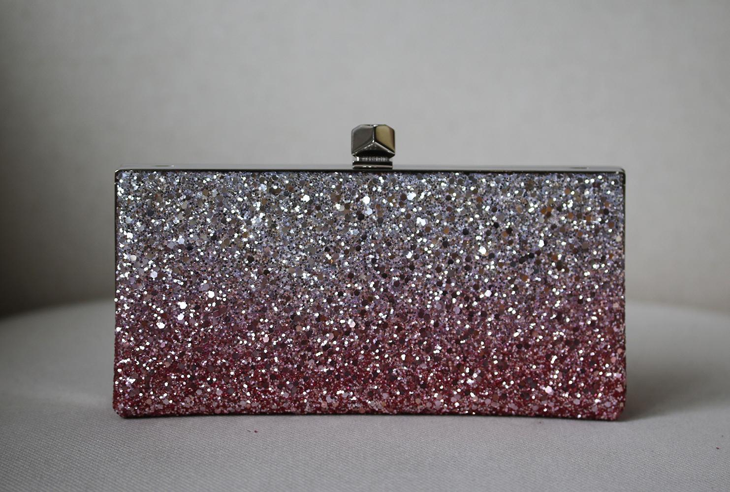 Jimmy Choo loves all things that sparkle - you can imagine the label's atelier swimming in glitter from all of its glamorous designs. This leather clutch opens with a crystal-tipped clasp to a satin-lined interior. Antique-rose and silver glittered
