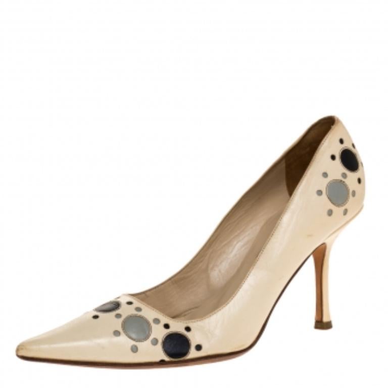 A simple pair of shoes transformed by Jimmy Choo with elements of circles. Crafted from leather, the pumps feature pointed toes, leather insoles and slim heels to lift your spirits in true JC style.