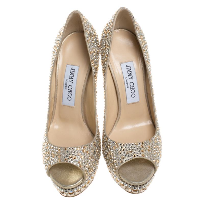 Let your style shimmer with these pumps from Jimmy Choo! Beautifully crafted from embellished leather, they feature peep-toes, 15 cm heels, and crystals embellished platforms. You're sure to love owning this gorgeous pair.

Includes: Price Tag,
