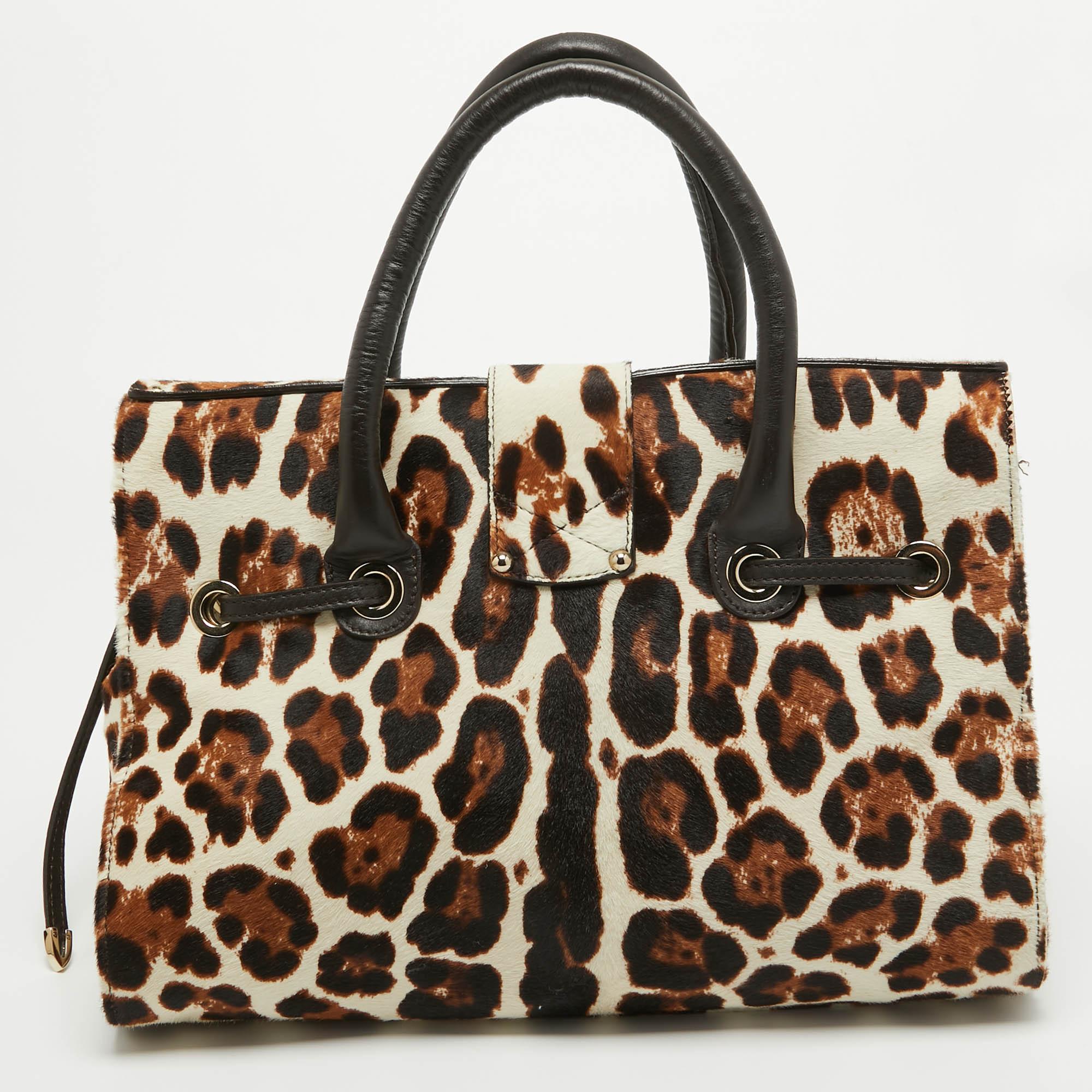Made from leopard-print calf hair and leather, this bag from Jimmy Choo is reliable and packed with style. It comes with a flip lock on the flap, a belt strap looped around it, and a well-sized Alcantara interior, whilst being held by two handles.