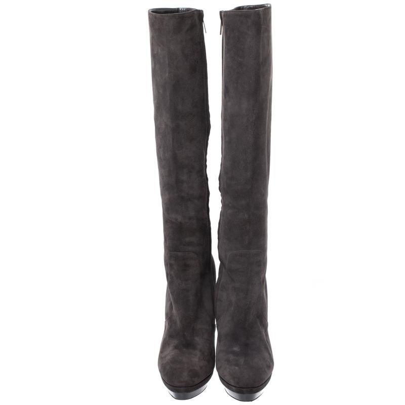 Simple and sophisticated, these knee-length boots from Jimmy Choo are a must-buy for the fashionable you. These boots are crafted in suede and come balanced on 14 cm heels and platforms. They can be paired with a long tunic or an oversized top to