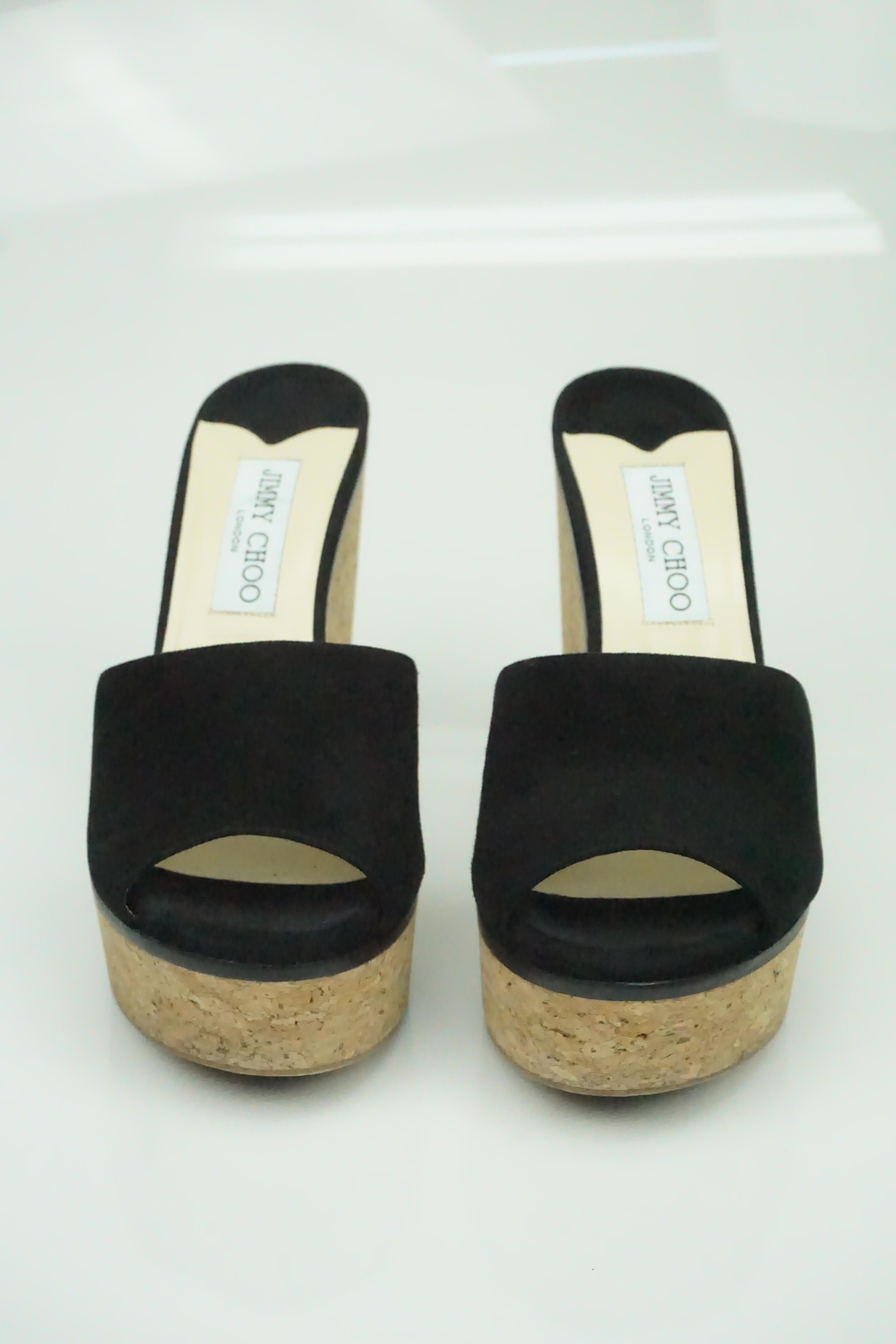 Jimmy Choo Deedee 125 Black Suede Sandal Wedges  - 38.5  These shoes are in excellent condition. The heel is made of a cork material and the lining on the top of the shoe is made of black suede as well as the foot strap. There is a gold detail on