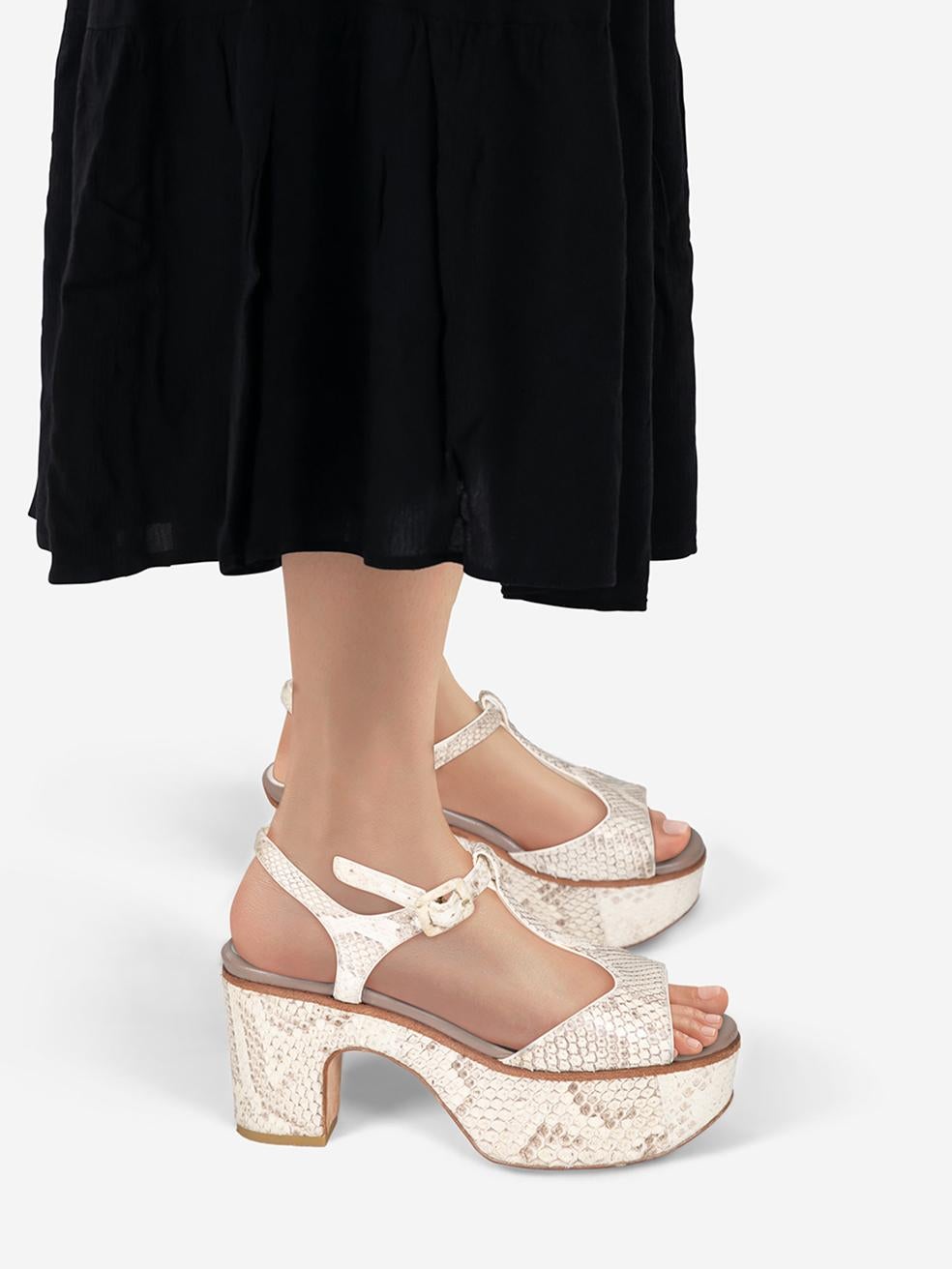CONDITION is Very good. Minimal wear to the sandals is evident. Marks on both insoles on this used Jimmy Choo designer resale item.
 
 
 
 Details
 
 
 Ecru
 
 Snakeskin
 
 Sandals
 
 Platform
 
 High block heel
 
 Open toe
 
 Adjustable ankle