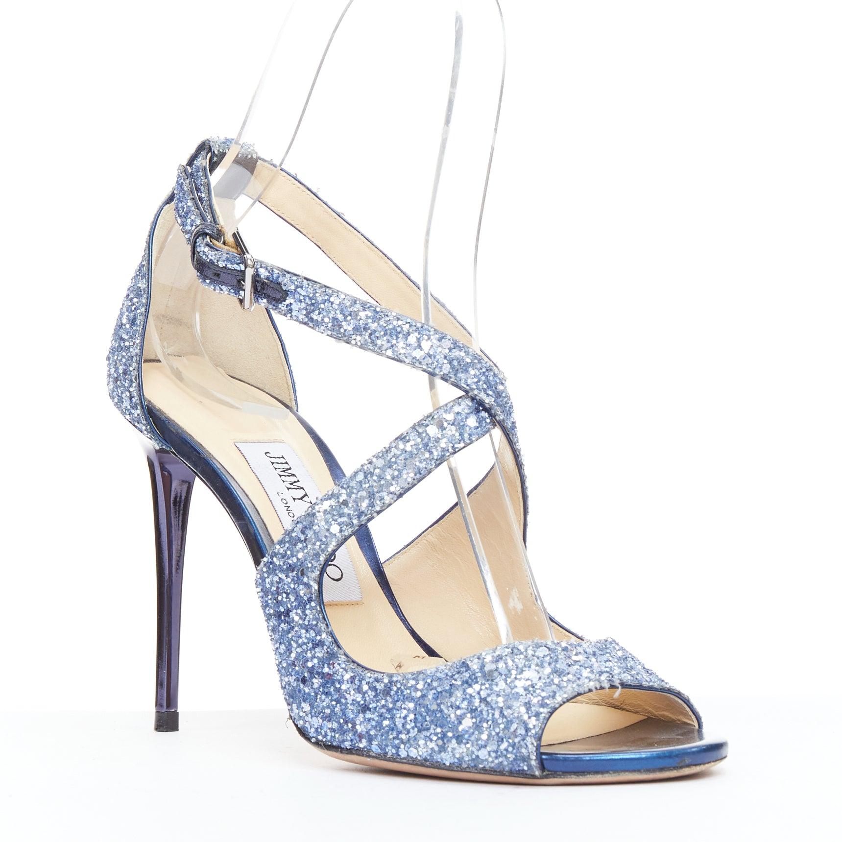 JIMMY CHOO Emily blue glitter crisscross strap open toe sandals EU36
Reference: JACG/A00192
Brand: Jimmy Choo
Model: Emily
Material: Fabric
Color: Blue
Pattern: Solid
Closure: Ankle Strap
Lining: Nude Leather
Extra Details: Metallic blue heels.
Made