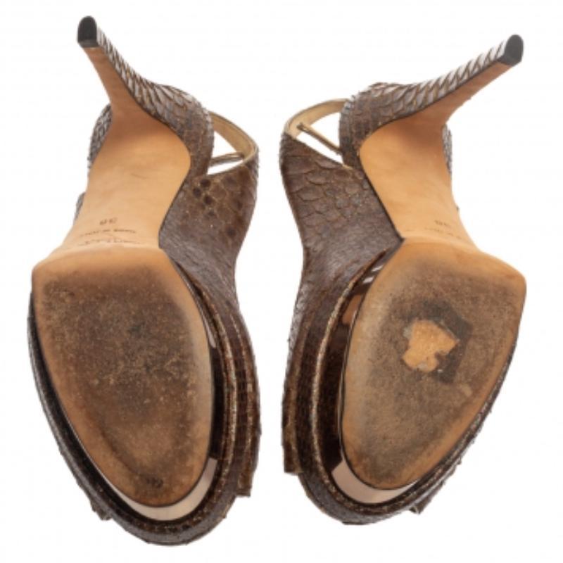 Pair that lovely maxi dress with these stunning brown sandals from Jimmy Choo! They are crafted from glitter effect python in a peep-toe silhouette and styled with buckled slingbacks. They come equipped with comfortable leather insoles, 12 cm heels,