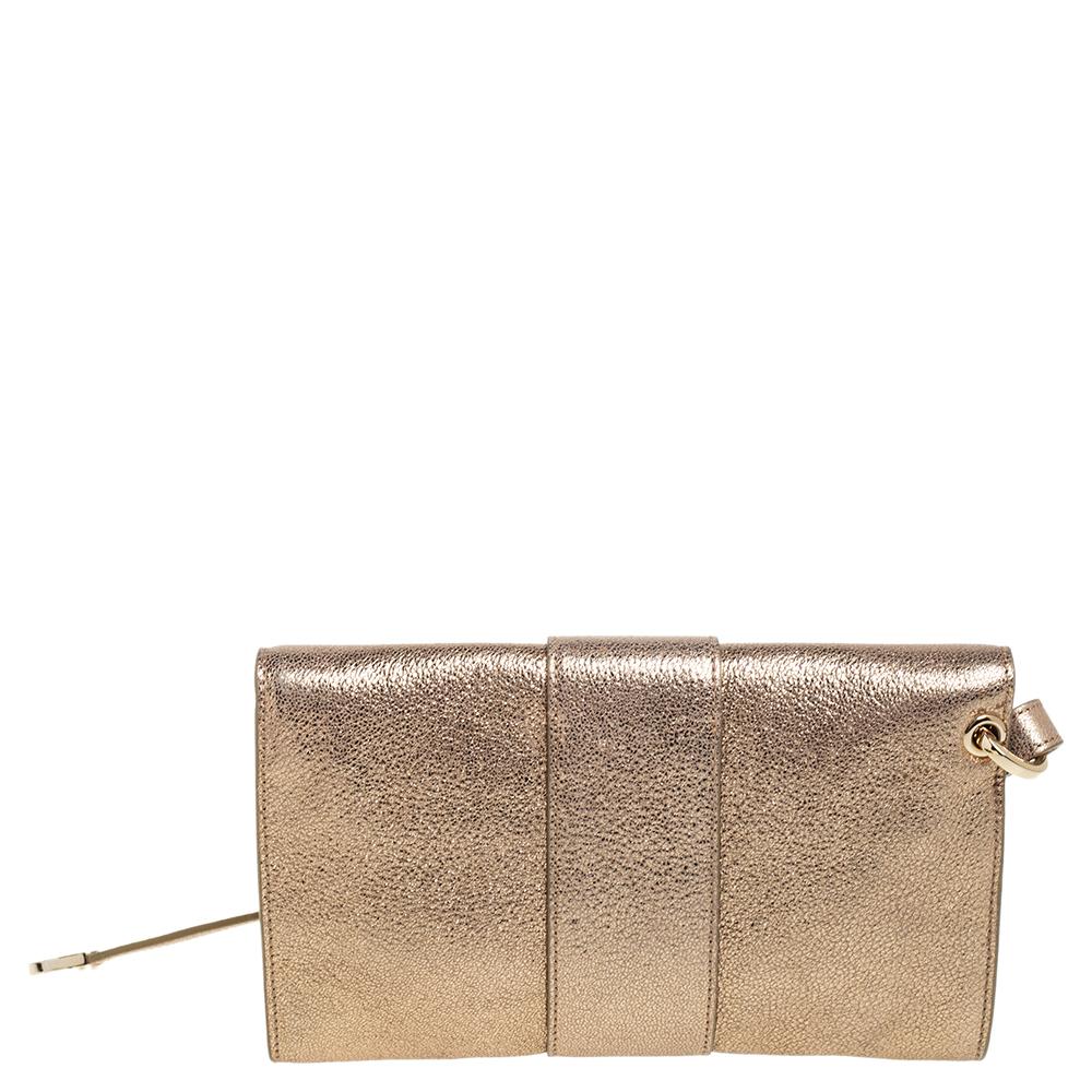 Be the star of the party by carrying this chic clutch by Jimmy Choo. Pretty and utilitarian, this clutch comes with a zippered pocket and enough space for little essentials within its glitter & leather body, enclosed with a flap closure.

Includes: