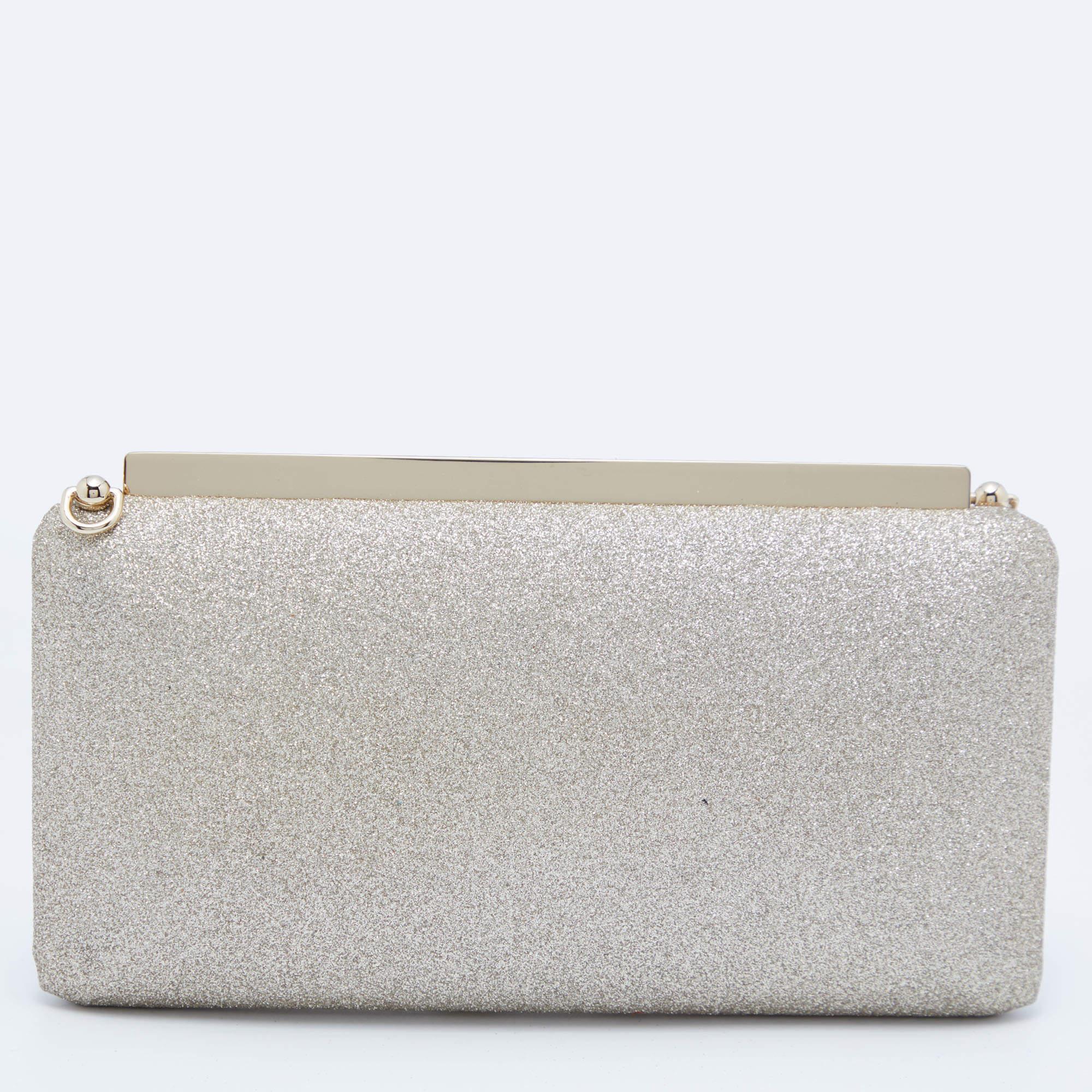 Be a head-turner at the next party with this shimmery leather clutch. The leather-lined interior feature multiple slots to keep your essentials neatly. This adorable creation is decorated with gold-tone accents and features a brand name engraved
