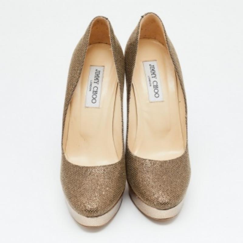 Dazzle away in comfort with these Jimmy Choo pumps. Expertly crafted from glitter fabric and embossed leather, the pumps feature covered toes, stable platforms, and 13.5 cm heels for a confident lift. Add them to your closet today!