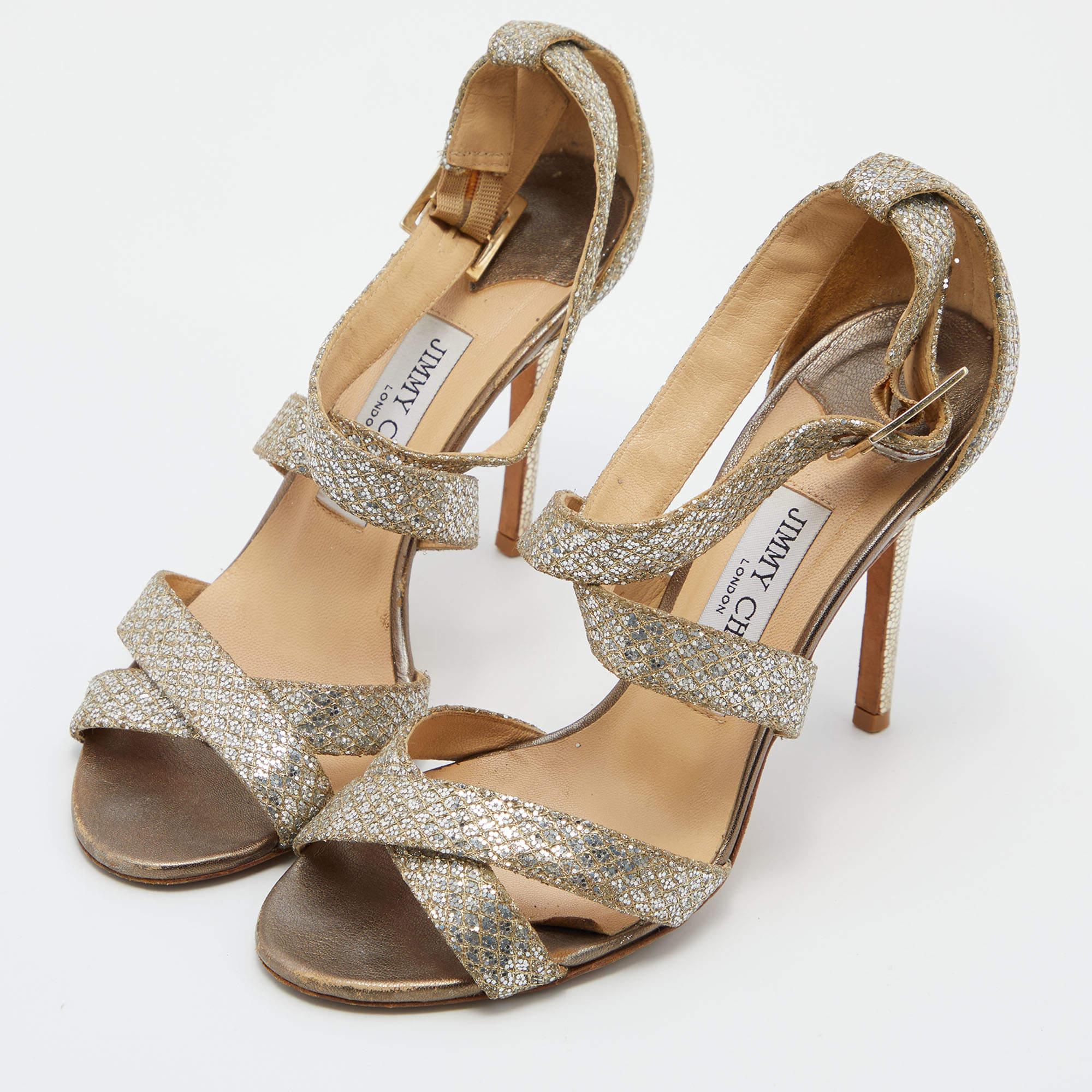 Jimmy Choo is known to create the ultimate glam and party shoes that are loved by fashion lovers all over  and these Louis sandals are just the right addition to your shoe collection. Constructed in a silver glitter adorned strappy leather pattern 