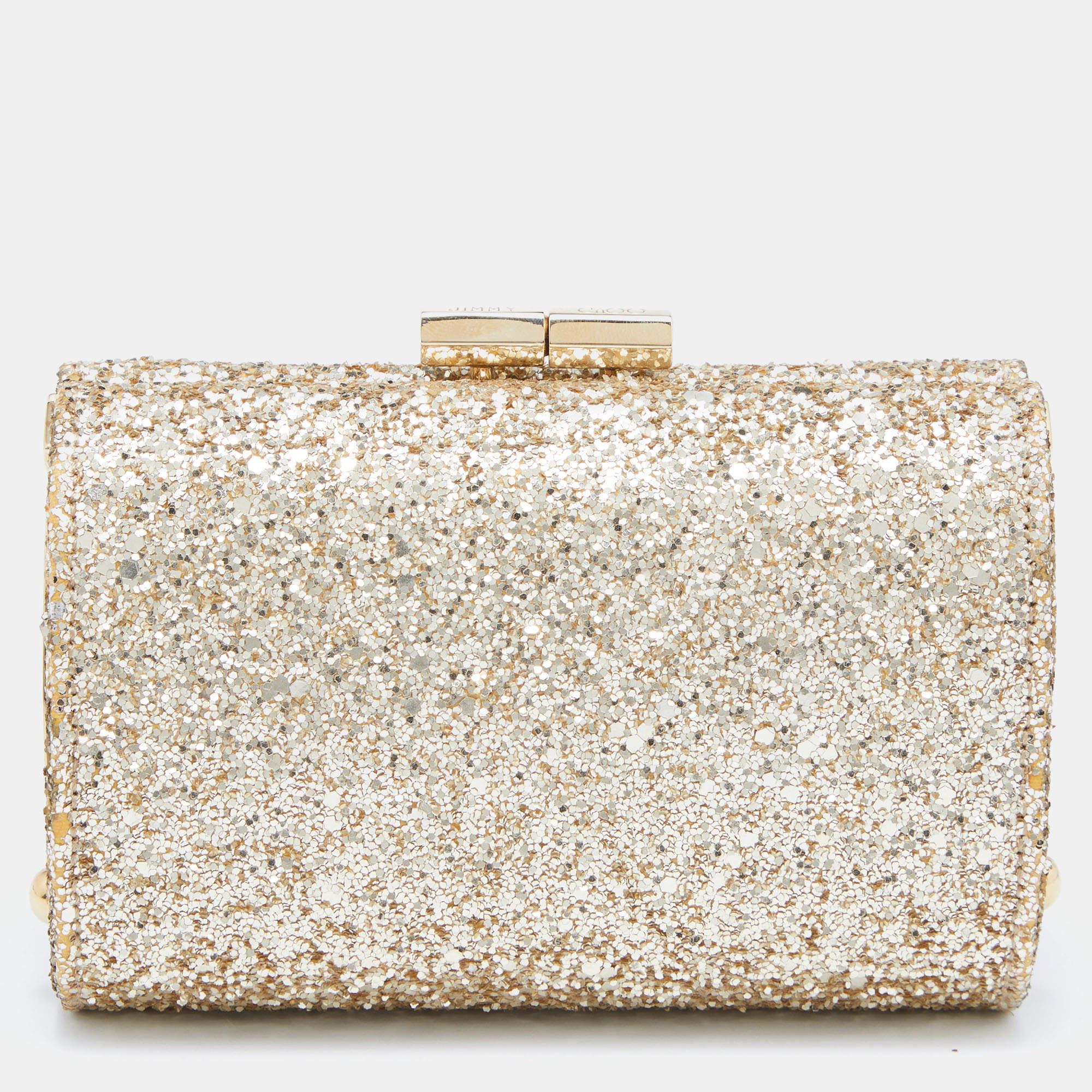 This Jimmy Choo clutch has a shimmery glitter exterior enhanced with gold-tone hardware. The satin-lined interior is sized to hold all your party essentials. This easy-to-carry clutch will garner you many compliments.

