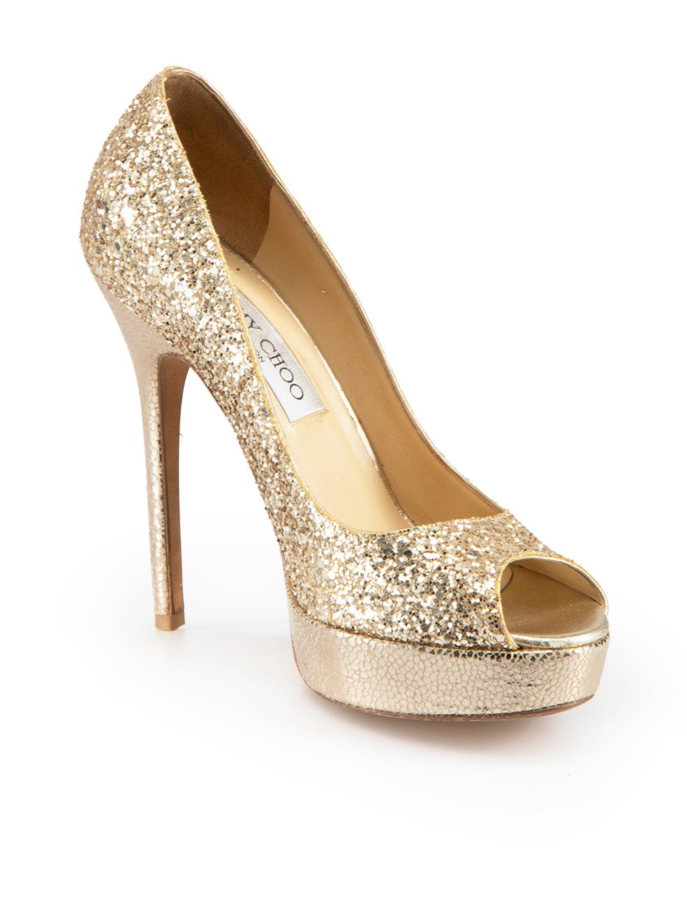 CONDITION is Good. Minor wear to heels is evident. Light creasing and discoloured marks to inner leather and minor scuff marks to both heels and toe caps on this used Jimmy Choo designer resale item.
  
Details
Gold
Glitter
High heels
Slip