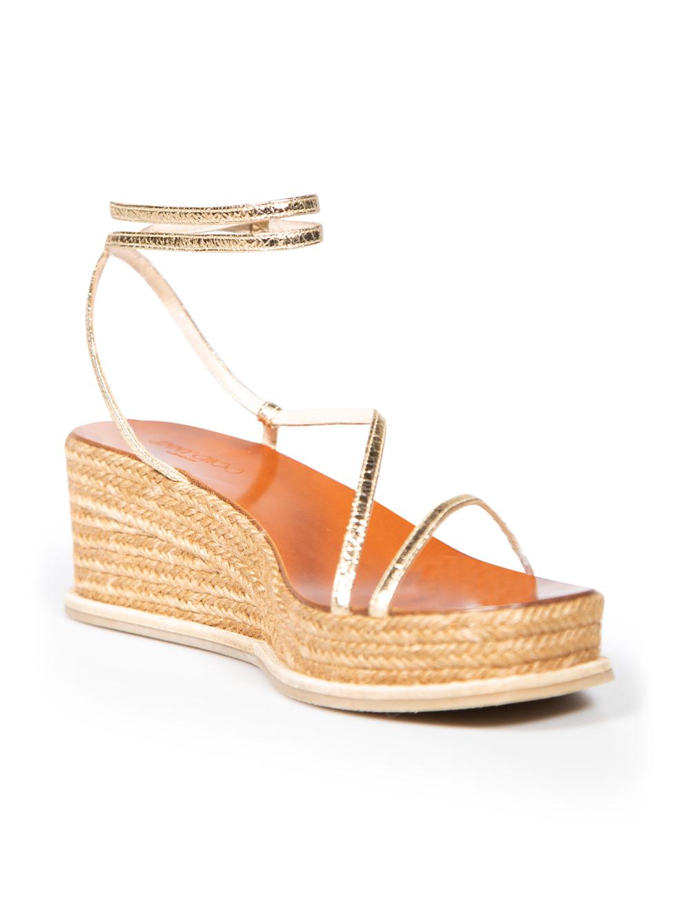 CONDITION is Very good. Hardly any visible wear to wedges is evident on this used Jimmy Choo designer resale item.
 
 
 
 Details
 
 
 Gold
 
 Leather
 
 Wedge sandals
 
 Open toe
 
 Platform
 
 Wrap around ankle strap
 
 
 
 
 
 Made in Spain
 
 
