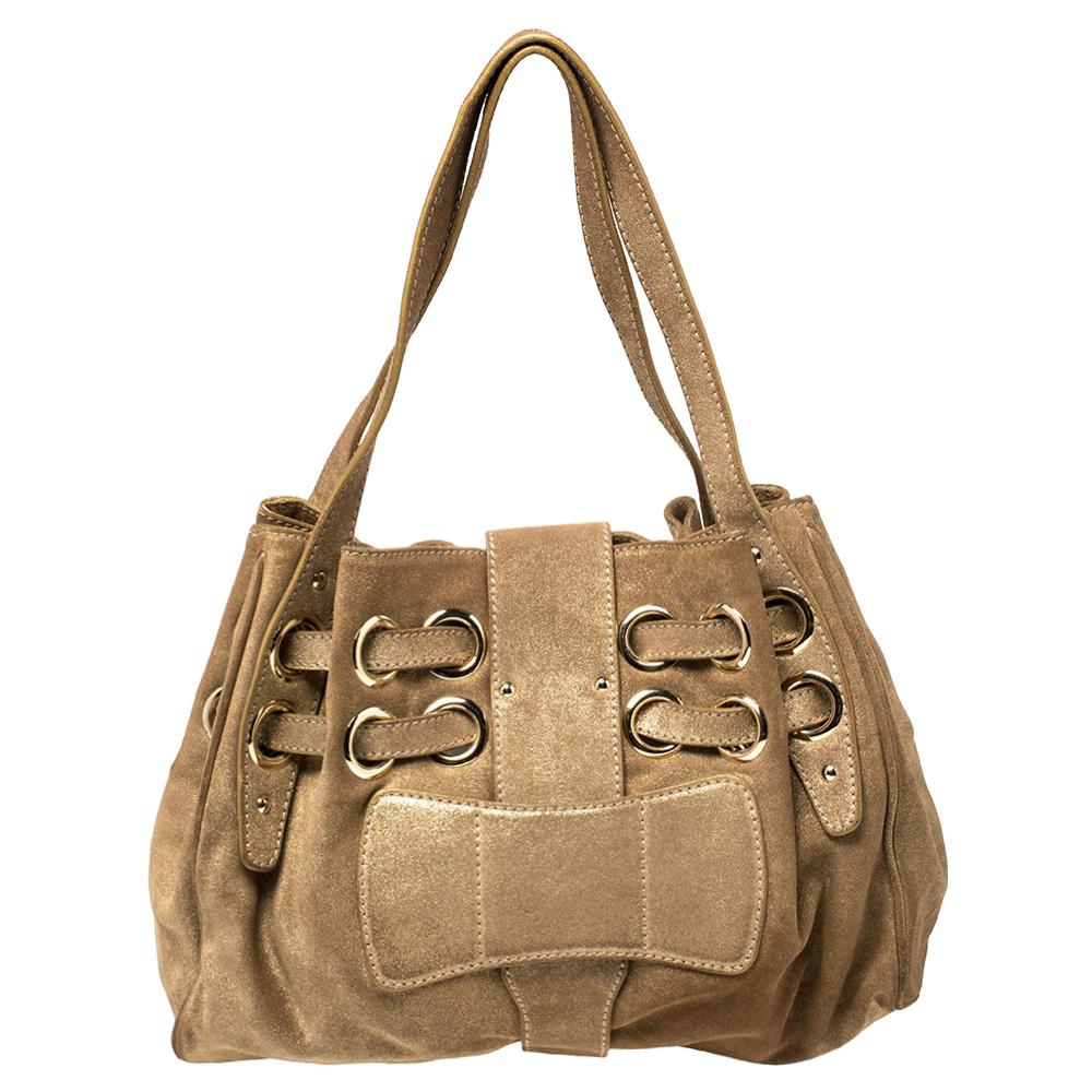The popular Ramona is another perfectly designed, practical handbag from Jimmy Choo. Crafted from gold shimmer suede, it is accented with double straps, a flip-lock closure, and dual shoulder handles. The interior is lined with suede and features a