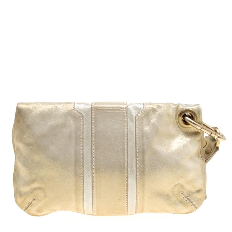 This elegant clutch from Jimmy Choo is comfortable to carry without compromising on style. Crafted in Italy from gold shimmering leather, the clutch features a wristlet and a foldover top. The interior is Alcantara-lined and has a zip