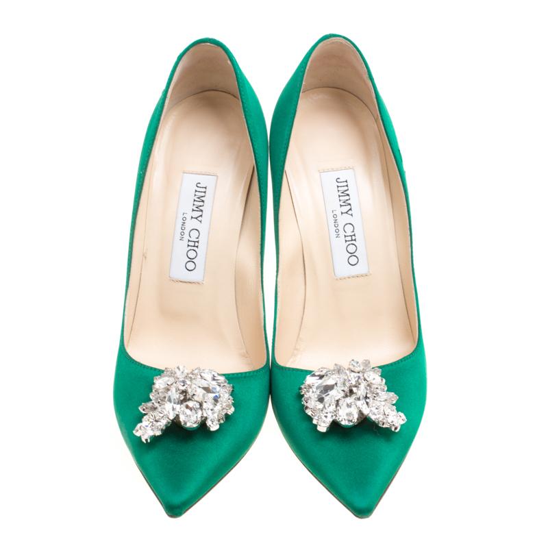 Crafted in green satin, these Jimmy Choo Manda pointed-toe pumps are a style saver for a party outing. The classiness of these pumps is further accented with a crystal-studded embellishment at the toes. Insoles are leather-lined. Wear these with an