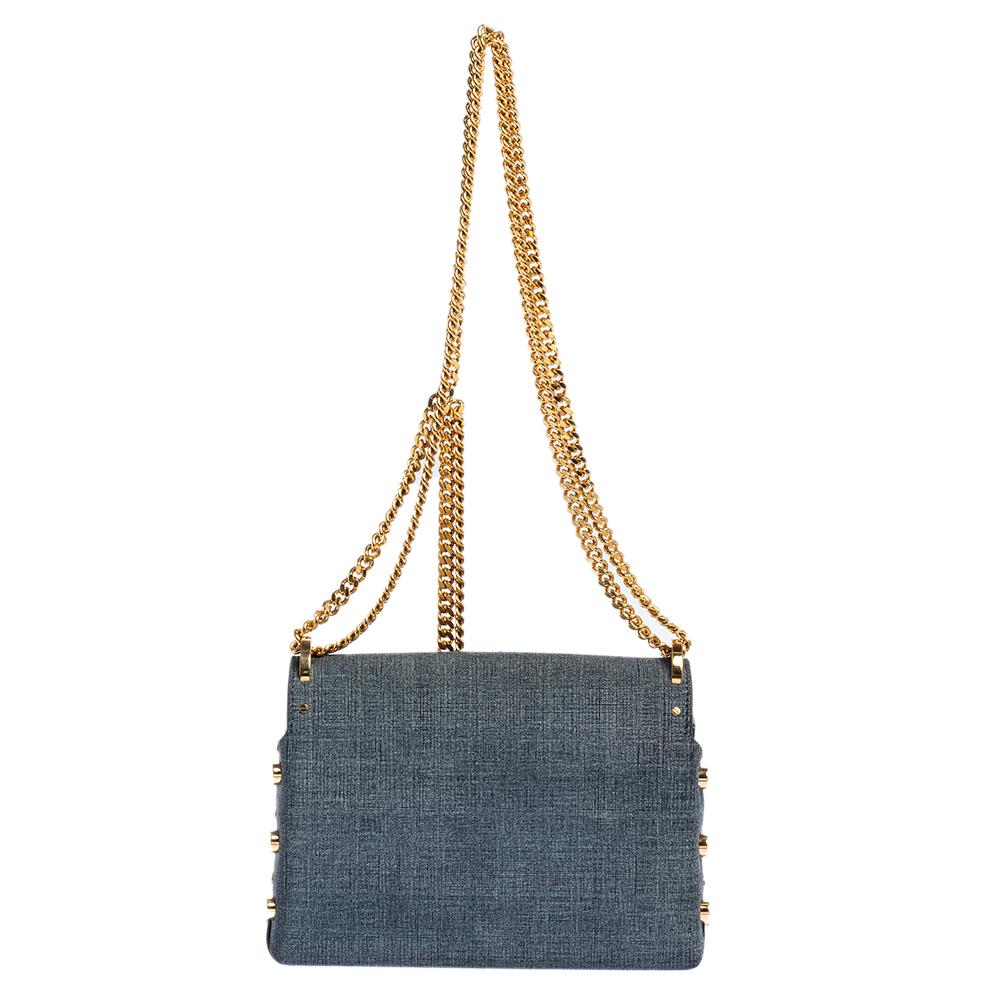 One of the main details of the Lockett by Jimmy Choo is the push-lock that has a pointed tip. This shoulder bag is highlighted with the same lock on its flap and it secures a suede interior for your needs. The bag has a grey canvas exterior,