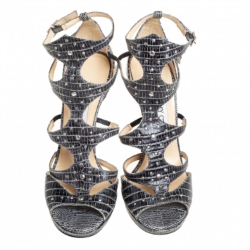 Flaunt style at its best with these beautiful grey sandals. The croc-embossed leather sandals from Jimmy Choo feature open toes, and studs all over. These chic sandals, set on 12 cm heels, are just what you need to take your style a few notches