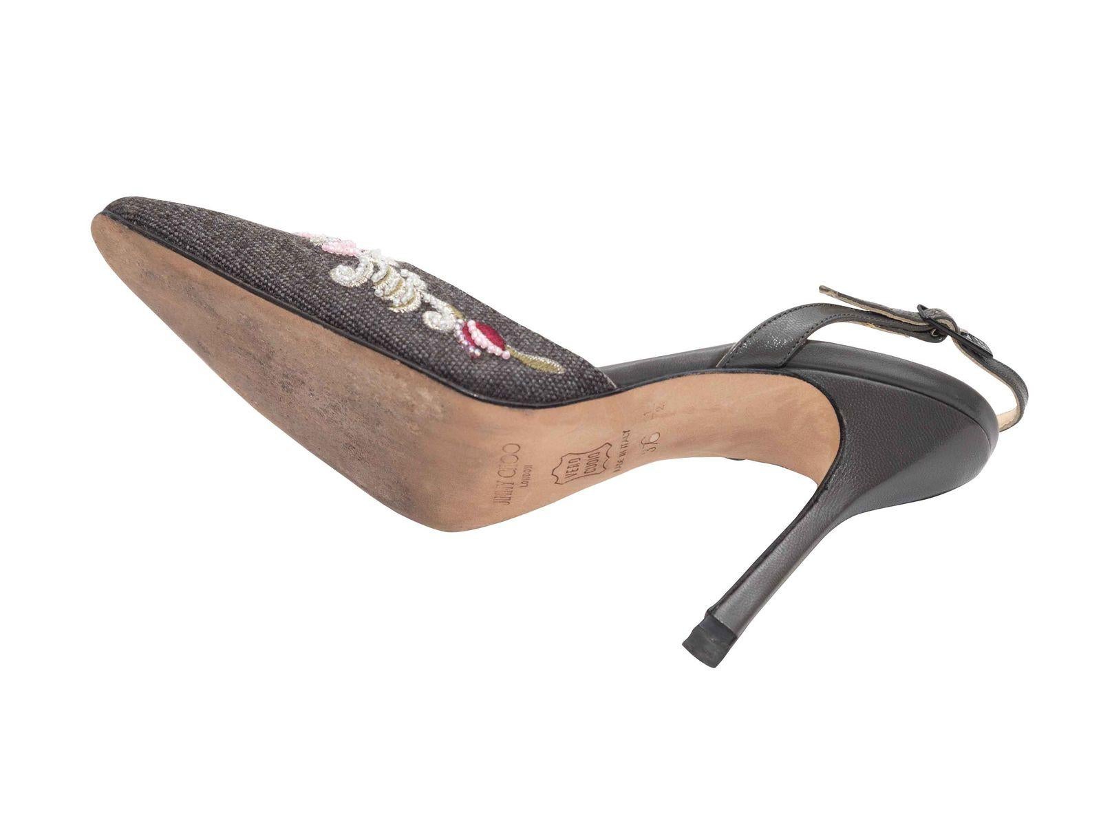 Product Details: Grey wool sling back heels by Jimmy Choo. Floral embroidery at tops. Leather-covered heels. Buckle closures at sling back straps. 3