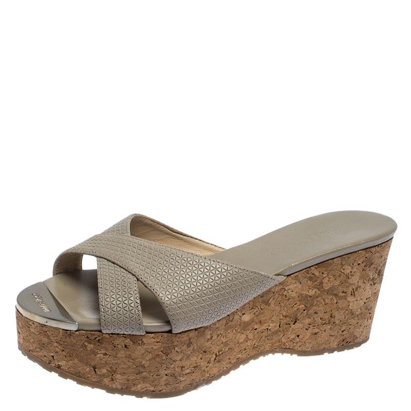 These lovely Jimmy Choo slides will bring you the right amount of style and shine. They feature crisscross straps on the vamps made from grey leather and 7.5 cm cork wedges. They are pretty and easy to flaunt.

Includes: Original Dustbag

