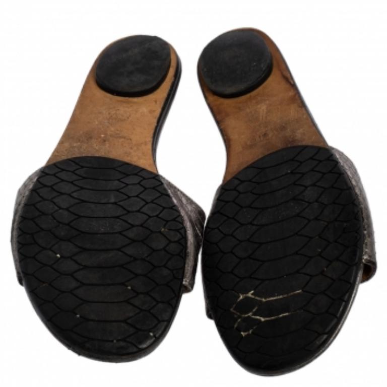 For days of ease and style, Jimmy Choo created these flat slides. They have uppers made from snakeskin leather in grey and insoles lined with leather for comfort. The slides will come in handy with many of your outfits.