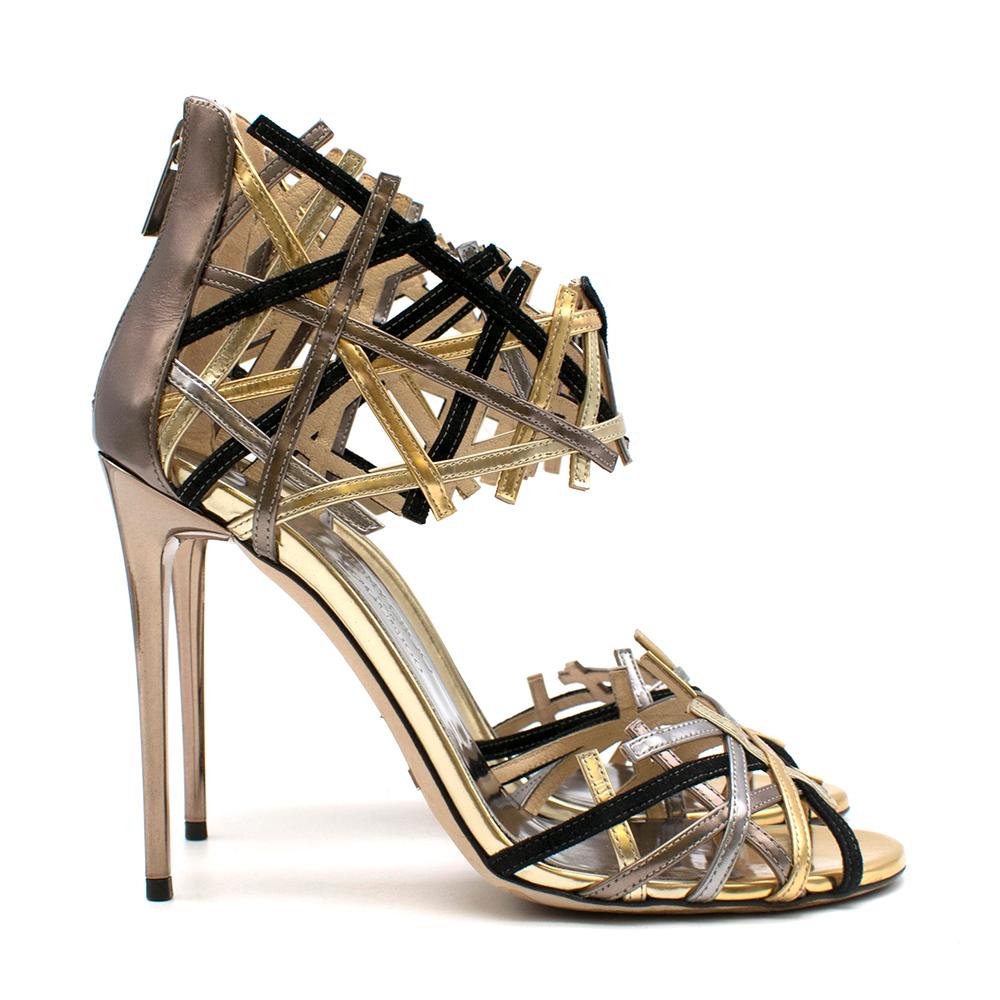 Jimmy Choo Hanover Vogue 100 Black and Gold Heels

- Jimmy Choo for Vogue 100 
- SS 2016
- Gold, Black, Silver, and Bronze detailing
- Zip up back
- Stiletto heel
- Ankle and toe sandal

Materials
- 100% Leather
- 100% Suede

Made in