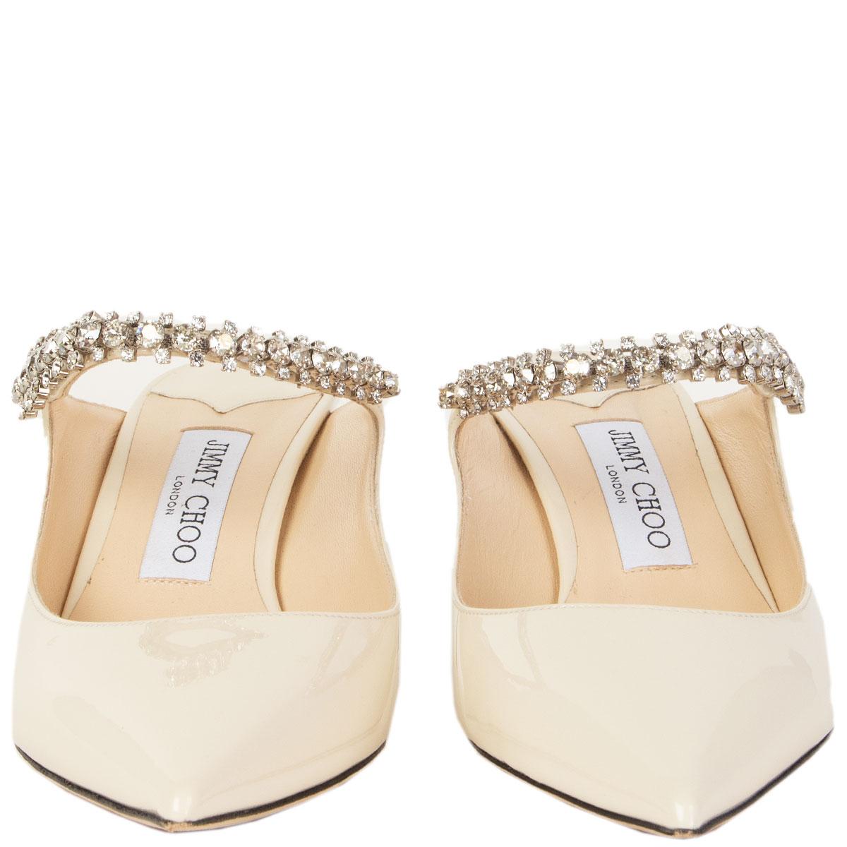 100% authentic Jimmy Choo Bing 65 pointed-toe kitten-heel mules in cream patent leather with a crystal embellished strap. Have been worn once inside and are in virtually new condition. 

Measurements
Imprinted Size	39.5
Shoe Size	39.5
Inside