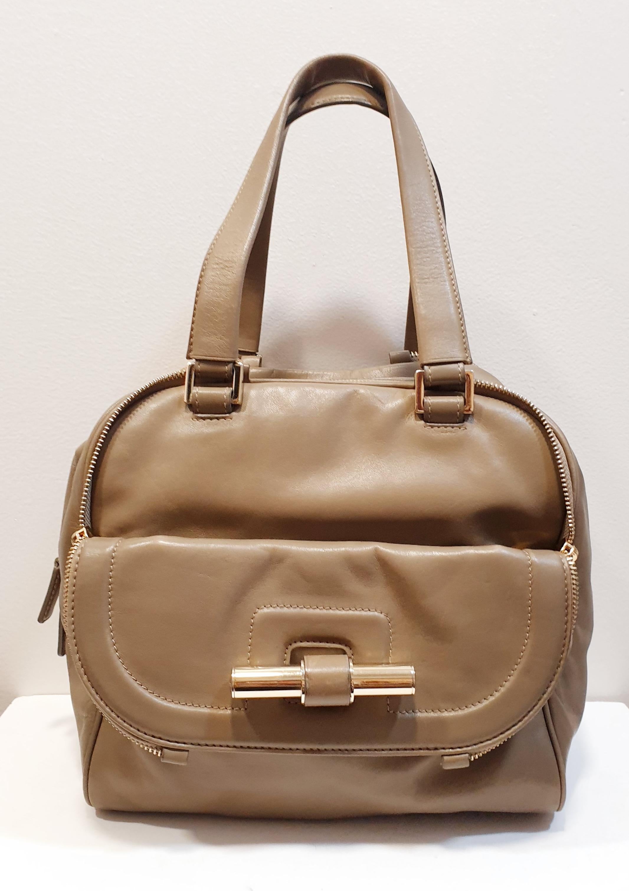 JIMMY CHOO bag Boston Justine model in taupe
 Taupe leather, gold trim, two flat leather handles, front patch pocket and flap pocket with zip, double top zip, beige canvas lining, one inside zip pocket.

Width: 25 cm  9,84 inches
Height: 23 cm  9,05