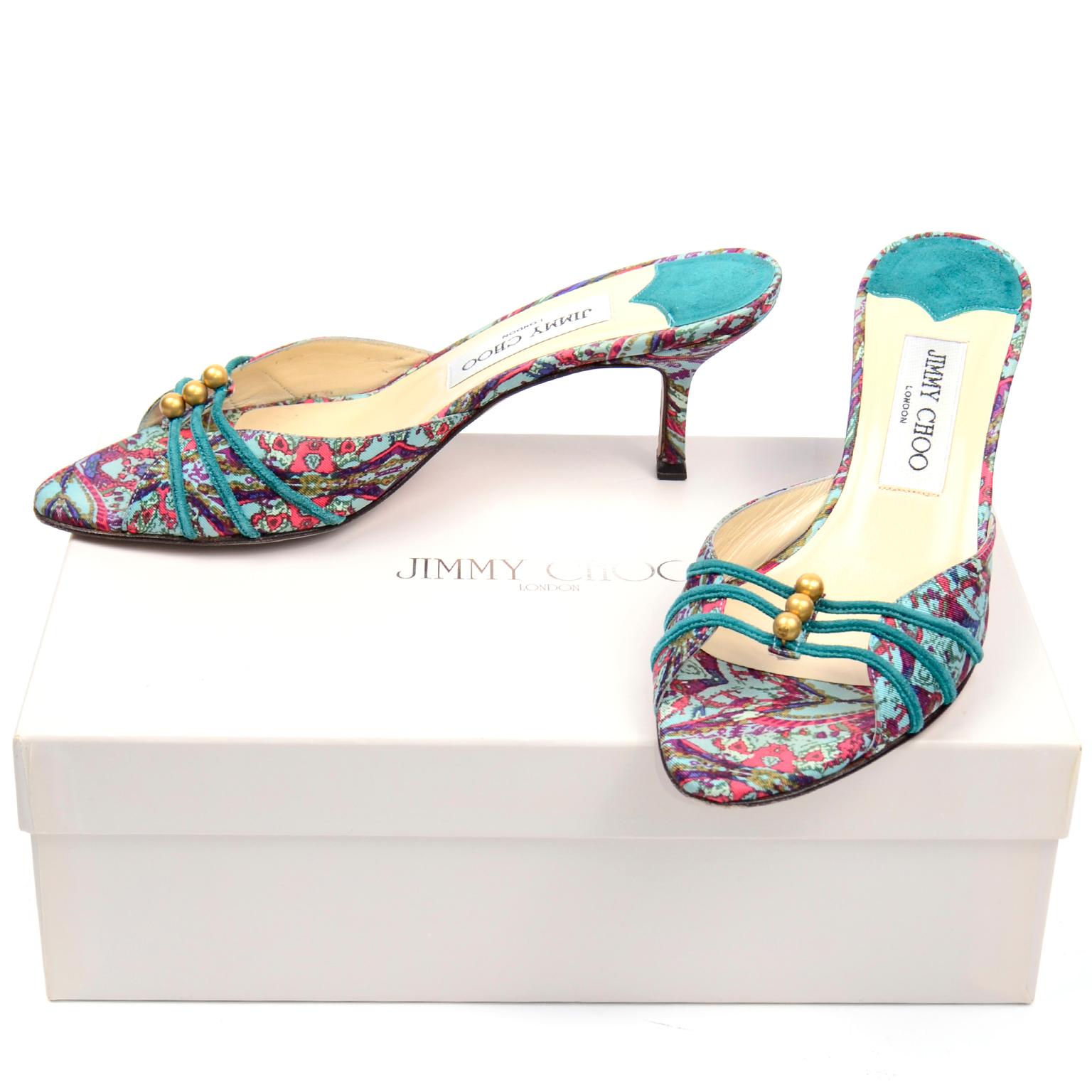 These are really fun turquoise green paisley print Jimmy Choo heeled mules. These shoes have a beautiful 3 strap with pretty gold beads with a slightly angled and pointed toe. The soles are made of leather and the shoes were made in Italy. The style