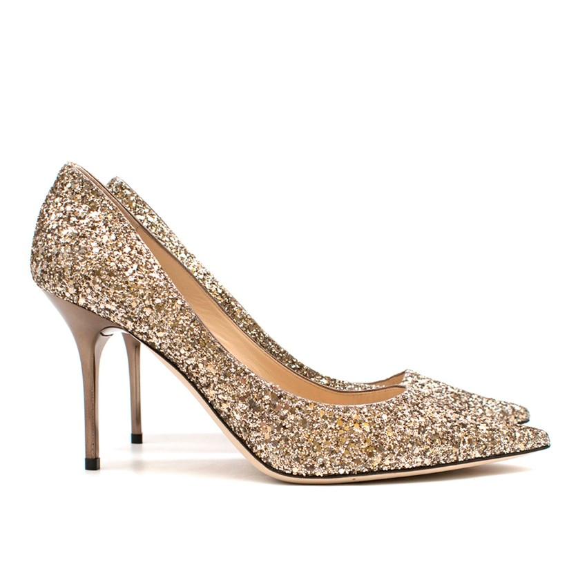 Jimmy Choo Love 100 Moon Sand Infinity Glitter Pointy Toe

-Gold, glitter infinity material
-Pointy toe 
-Stiletto heel
-Leather lined
-Leather sole
-Slight storage marks on sole, but unworn

Please note, these items are pre-owned and may show some