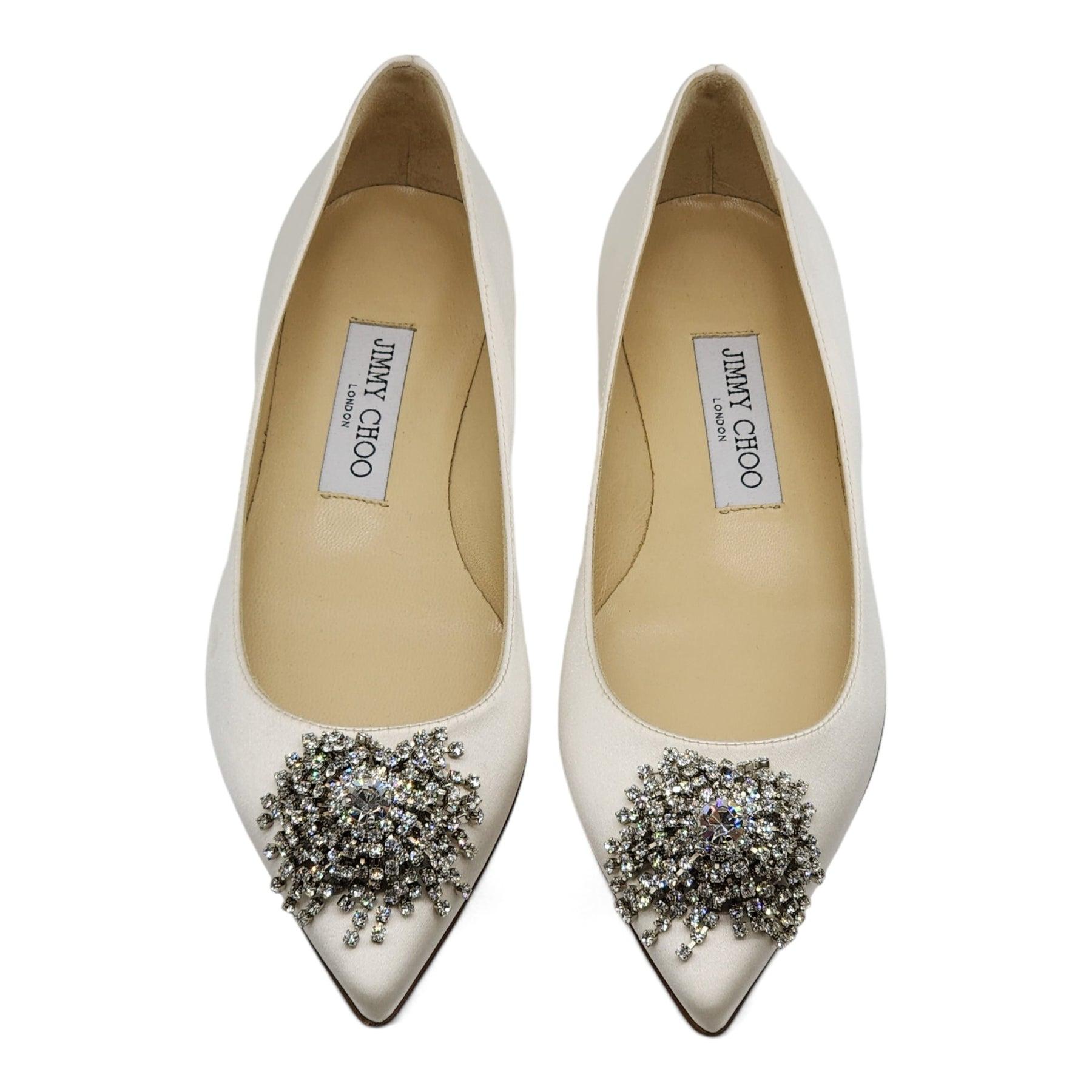 Jimmy Choo Love Embellished Satin Flat Ballerina Shoes in White.

Additional information:
Material: Satin & Leather
Pointed toe
Slip on
Embellished detail on the top
Satin upper, leather lining and sole
Color: White
Size: 36.5 EU (6.5 US)
Condition: