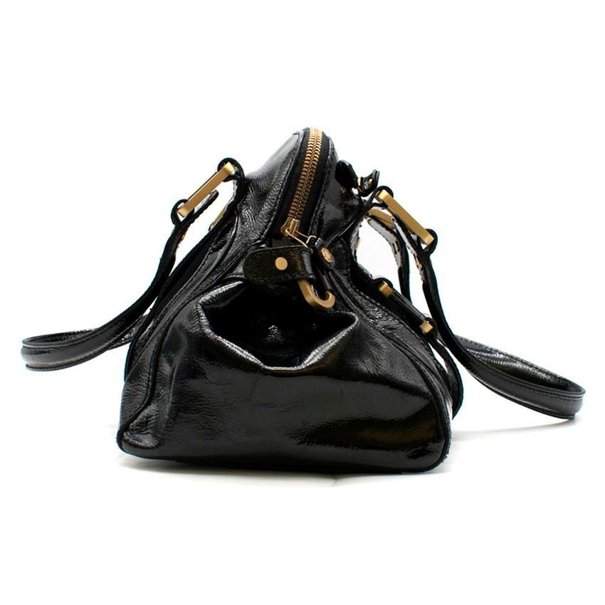 Jimmy Choo Malena Black Patent Leather Handbag
 
 - Black patent leather handbag
 - Suede contrast panel
 - Top handles
 - Front and back strap detailing
 - Front metal hardware with logo engraved
 - Front zipped pocket
 - Zip fastening
 - Internal