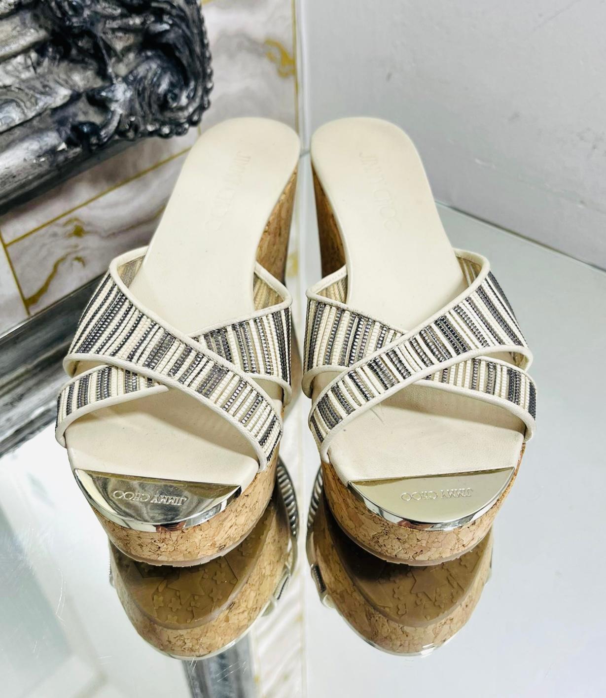 Jimmy Choo Mesh, Leather & Cork Wedge Sandals

Ivory sandals designed with wide, criss-cross metallic mesh straps.

Detailed with brown cork wedge and leather insoles with silver, 'Jimmy Choo' logo engraved toe plate; rubber soles.

Size –