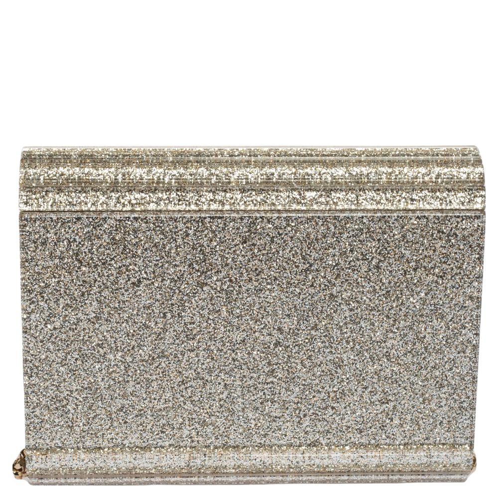 This clutch by Jimmy Choo has been wonderfully crafted from metallic champagne-glitter acrylic and leather and shaped to complement your elegant outfits. The interior of this clutch is perfectly sized to carry your necessities. Simple yet chic, this