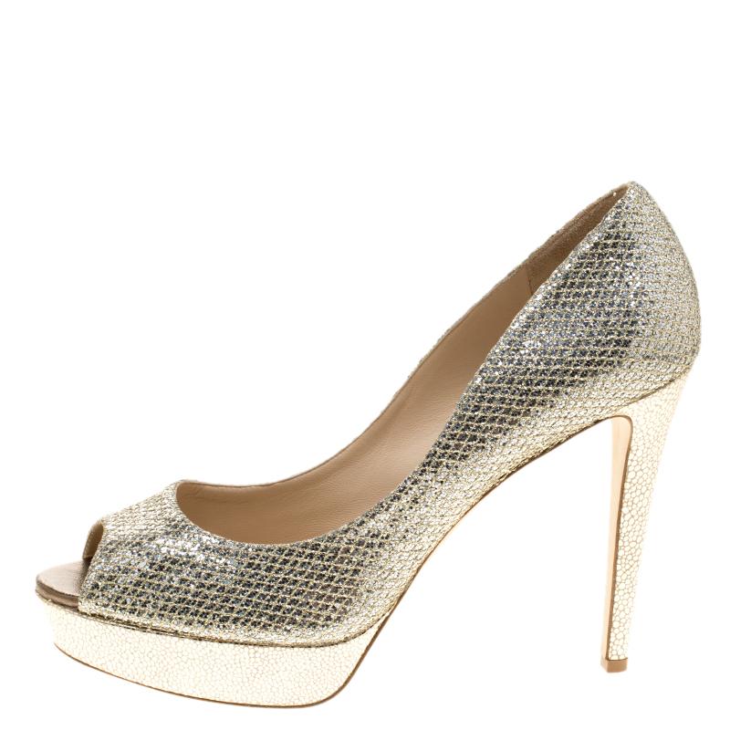 Create a new look by combining your outfit with this pair of dressy Jimmy Choo pumps. Crafted from glitter fabric, they are lined with leather on the inside. This pair sports 12.5 cm heels and 2.5 cm platforms.

Includes: Original Box

