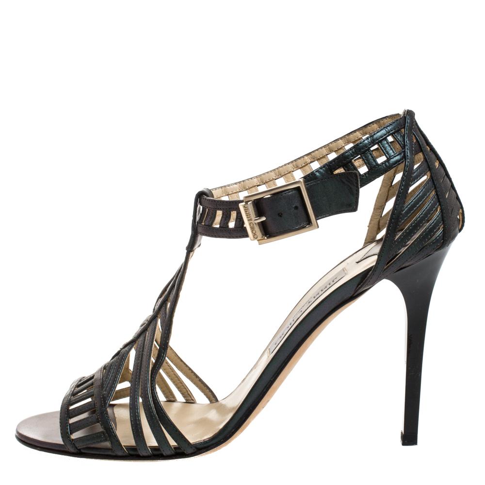 These sandals from Jimmy Choo are a great way to elevate your outfits. Crafted in Italy, they are made from quality leather and come in a metallic dark green hue. They are styled with cut-out detailing, open toes, 11 cm heels and buckled ankle