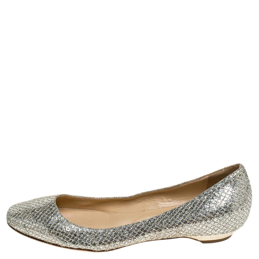 For a laidback yet stylish ensemble pick these this pair of flats from Jimmy Choo that speaks nothing but comfort and fabulous design. They've been crafted with metallic gold glitter fabric and have a shimmery effect all over. The comfy flats,