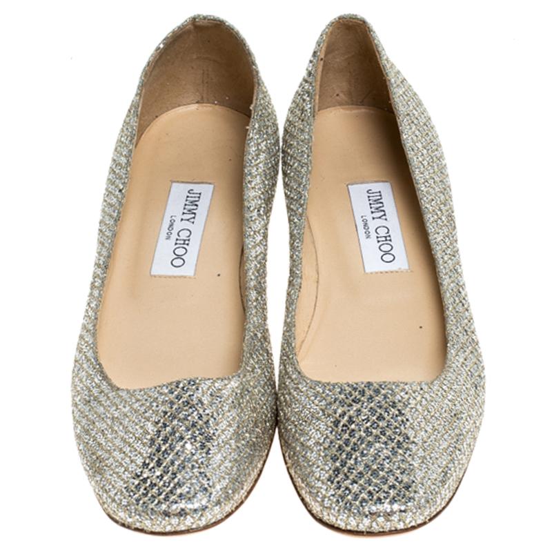 For a laidback yet stylish ensemble pick these this pair of flats from Jimmy Choo that speaks nothing but comfort and fabulous design. They've been crafted with metallic gold glitter fabric and have a shimmery effect all over. The comfy flats,