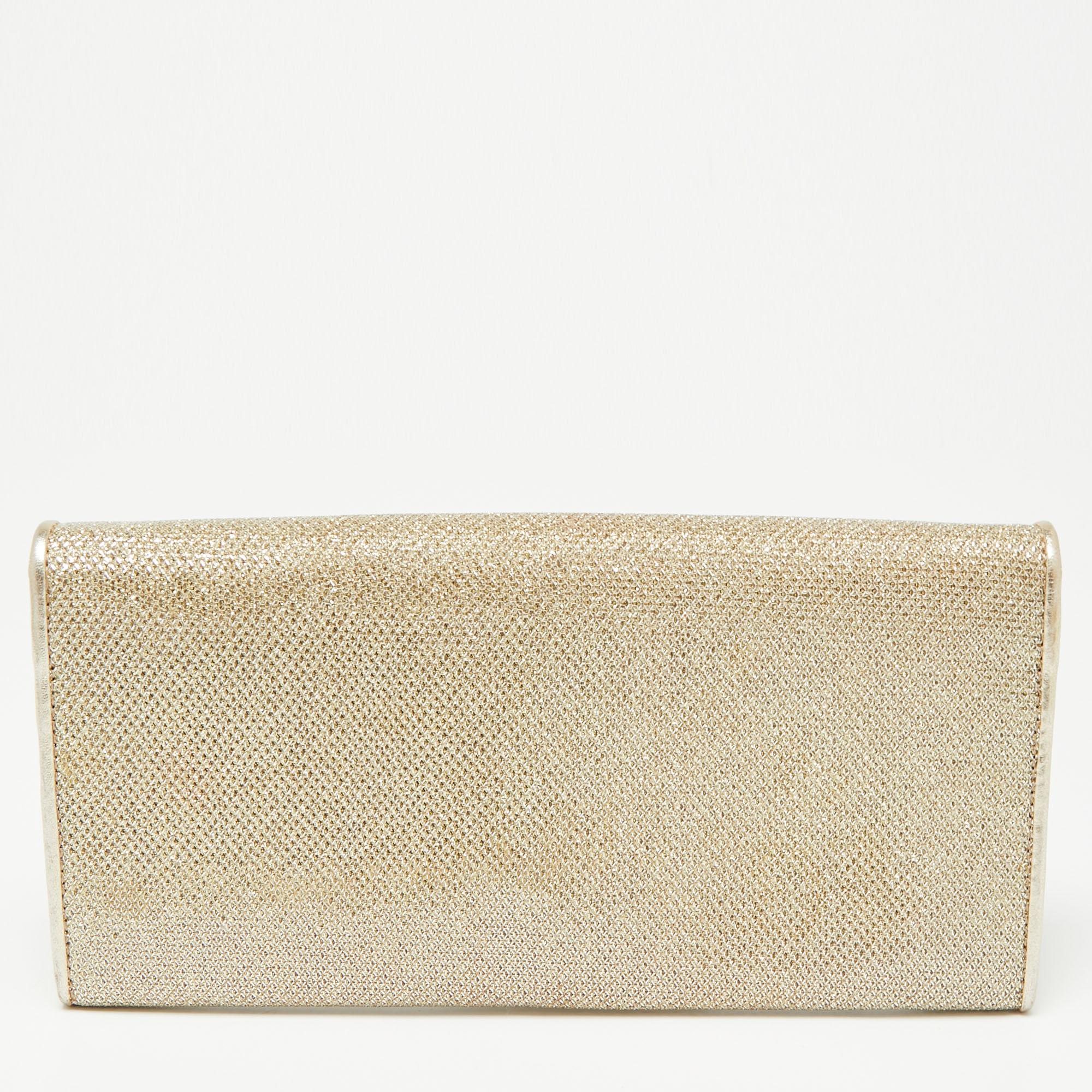 A versatile, modern style with a sleek silhouette, this Jimmy Choo glitter clutch is a great party piece. It features a compact interior of fabric and leather. A glamorous design, it is complete with matching gold-tone hardware.

Includes: Original