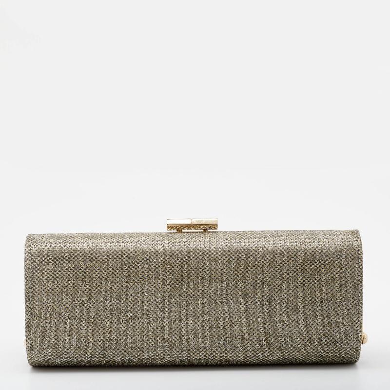 Accessorize your party outfit with this Jimmy Choo clutch. Created from glitter, it features a stunning display and is beautified with gold-tone accents. The satin-lined interior of the clutch is secured by a top lock closure.

Includes: Original