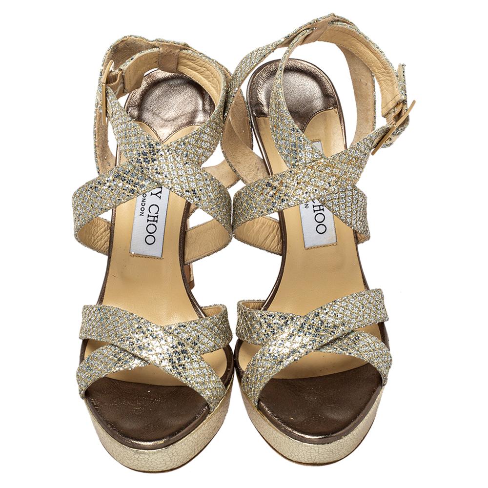 Jimmy Choo is known to create the ultimate glam and party shoes that are loved by fashion lovers all over, and these sandals are just the perfect example. Constructed in metallic gold glitter straps, these shoes feature buckled closure at the ankles