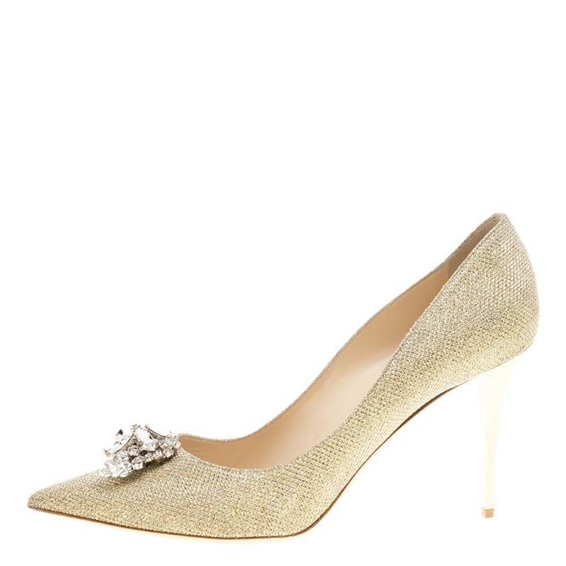 This pair of pumps by Jimmy Choo is a classic. These pumps are lined with leather and create a snug fit. This pair of impressive metallic pumps is made from Lame Glitter Fabric and designed with crystals on the pointed toes and 10 cm