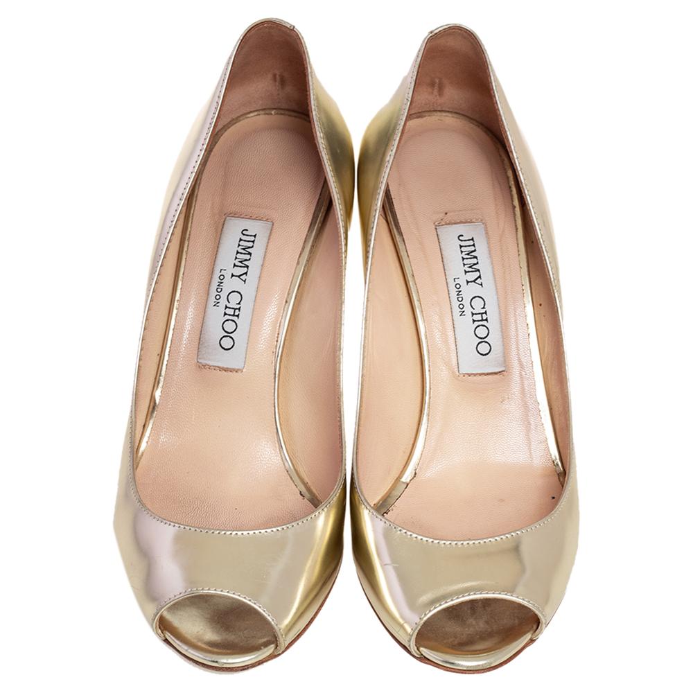 These timeless Jimmy Choo Baxen pumps will bring just the right amount of height to daytime looks. Crafted in metallic gold patent leather, they feature classic peep toes, leather insoles and wedge heels for all-day comfort.

