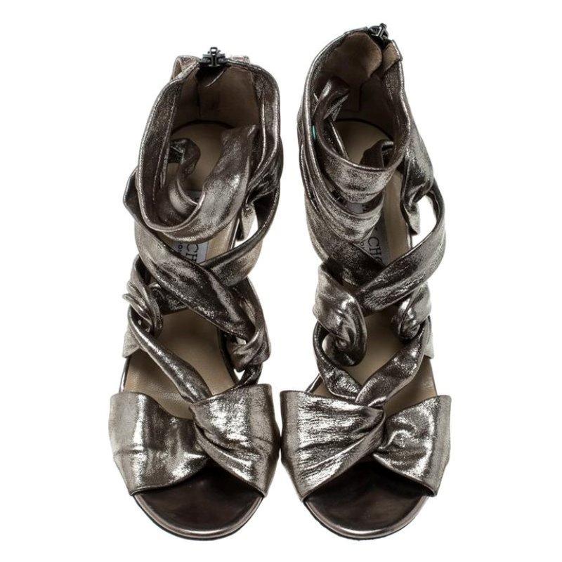 Designed with a strappy front, these sandals from Jimmy Choo are love at first sight. The metallic grey leather body and the 10 cm high stiletto heels are the features that will keep you intrigued. They have open toes and leather-lined insoles. Team