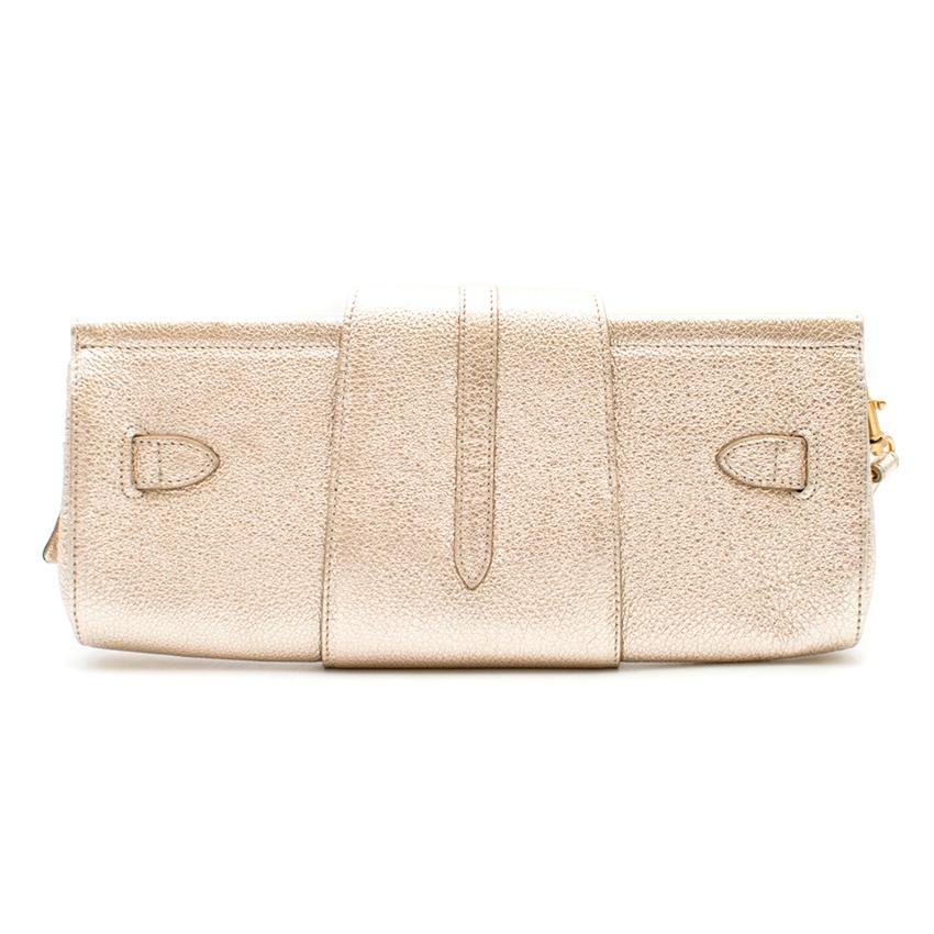 Jimmy Choo Metallic Leather Clutch

- Grainy pale gold/silver metallic leather clutch
- Foldover flap closure 
- Buckle detailing on the front with Jimmy Choo logo embossed
- Suede lining with zipped flat pocket and slip pocket
- Matt gold-tone