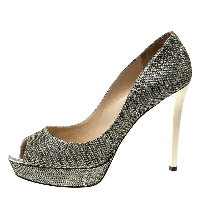 Flaunt an elegant look in this pair of pumps made from lamè glitter fabric. Ideal for glitzy events, they come in metallic light bronze with peep toes, platforms, and 12.5 cm heels. Exquisitely designed, these are from the luxury house of Jimmy
