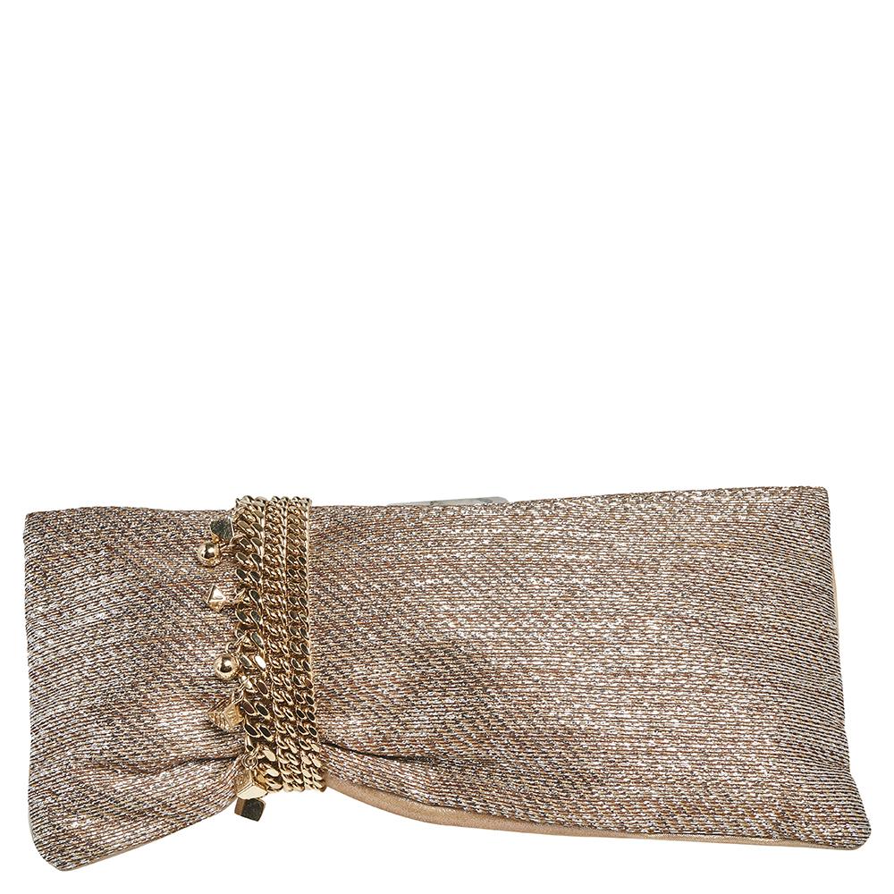 Elegant and glamorous, Jimmy Choo's Chandra clutch is a fashionable accessory. So, add it to your collection with this piece. Crafted from lurex fabric and suede, the clutch is styled with chain detailing wound around the clutch and ending as the
