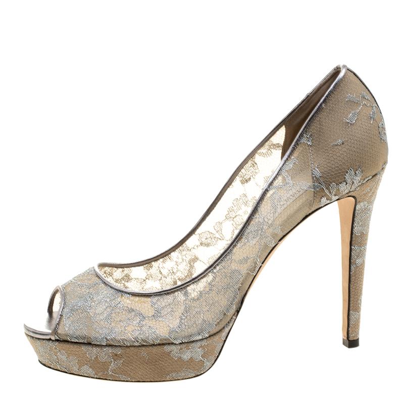 Mesmerizing and stylish, this pair of metallic silver pumps from Jimmy Choo is here to win your love. Perfectly crafted from a mix of lace, and leather, these pumps are designed with peep toes, 12.5 cm heels and platforms for maximum support and