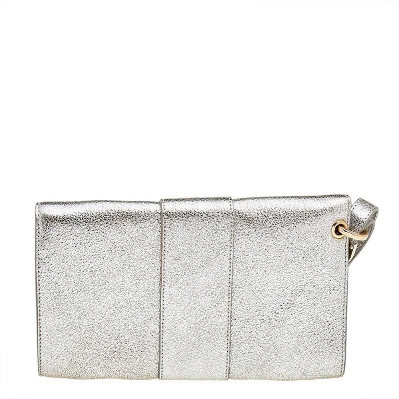 Be the star of the party by carrying this chic clutch by Jimmy Choo. Pretty and utilitarian, this clutch comes with a zippered pocket and enough space for little essentials within its metallic silver leather body, enclosed with a flap